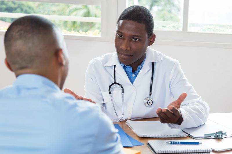 Doctor talking to patient at desk